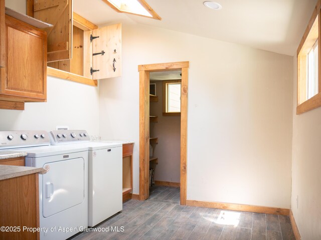 783 Orchard Rd, Montrose, CO 81401 - laundry area with cabinet space, independent washer and dryer, wood finished floors, and baseboards