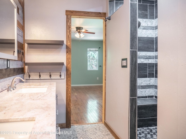 783 Orchard Rd, Montrose, CO 81401 - kitchen featuring a sink, ceiling fan, open shelves, baseboards, and light countertops