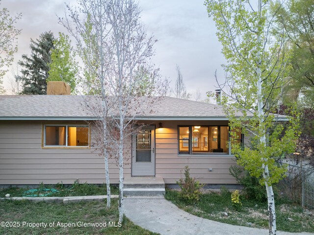 783 Orchard Rd, Montrose, CO 81401 - ranch-style home featuring a chimney, a porch, and a shingled roof