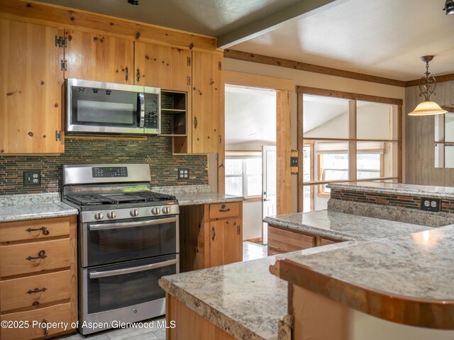 783 Orchard Rd, Montrose, CO 81401 - kitchen featuring appliances with stainless steel finishes, decorative backsplash, pendant lighting, and light stone countertops