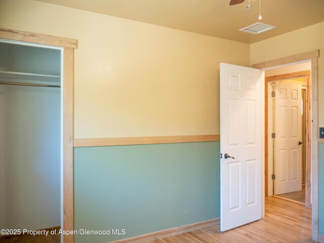 783 Orchard Rd, Montrose, CO 81401 - unfurnished bedroom featuring wood finished floors and a closet