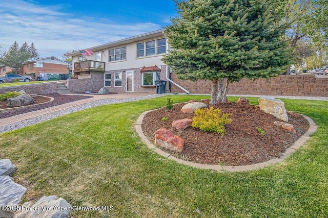 301 W 10th St, Craig, CO 81625 - back of property with a balcony, a yard, stucco siding, and brick siding