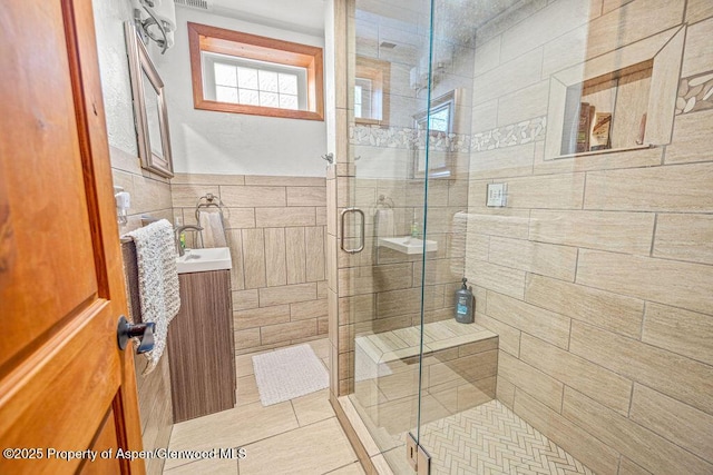 301 W 10th St, Craig, CO 81625 - full bathroom featuring a shower stall, vanity, tile walls, and tile patterned flooring