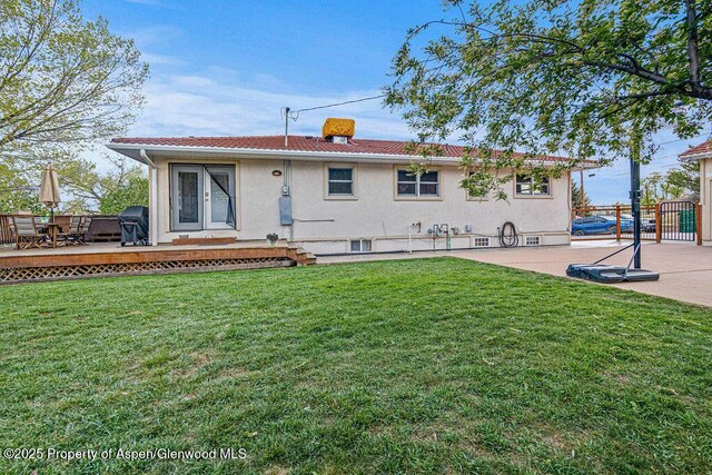 301 W 10th St, Craig, CO 81625 - back of property with stucco siding, a deck, and a patio