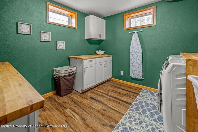 301 W 10th St, Craig, CO 81625 - laundry area featuring cabinet space, separate washer and dryer, dark wood-type flooring, a textured wall, and baseboards