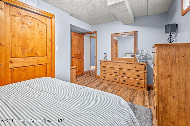 301 W 10th St, Craig, CO 81625 - bedroom featuring wood finished floors, a textured ceiling, and baseboards