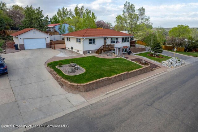 301 W 10th St, Craig, CO 81625 - view of front of property featuring driveway, stucco siding, stairs, a tiled roof, and an outdoor structure