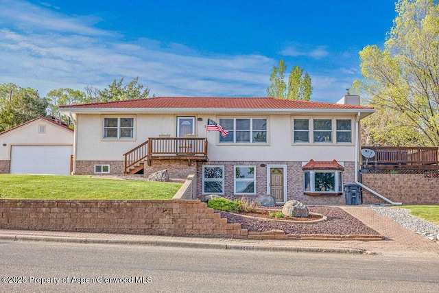 301 W 10th St, Craig, CO 81625 - view of front facade featuring an outbuilding, a detached garage, a front lawn, a chimney, and stucco siding