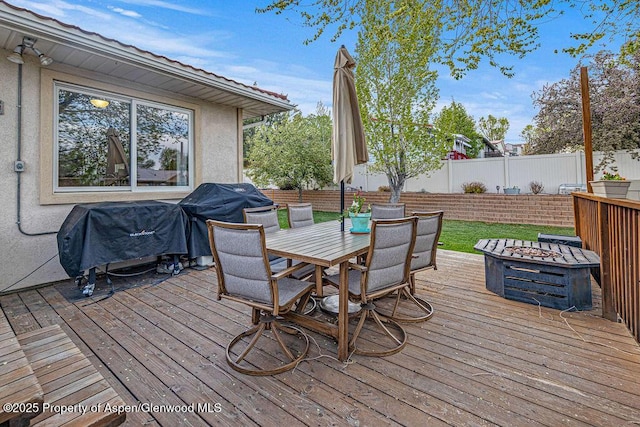 301 W 10th St, Craig, CO 81625 - deck featuring a fenced backyard, outdoor dining area, a fire pit, and a grill