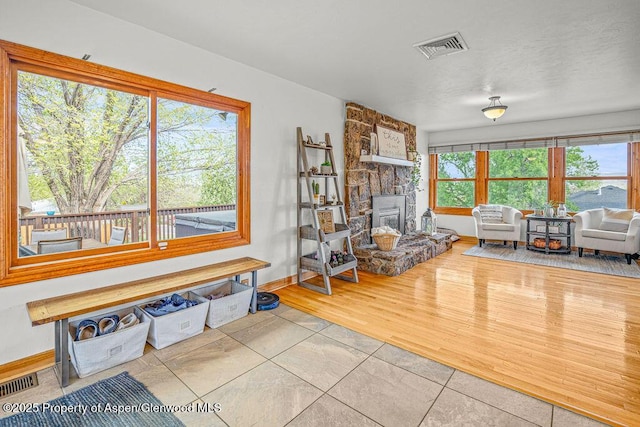 301 W 10th St, Craig, CO 81625 - living room with a stone fireplace, baseboards, and tile patterned flooring