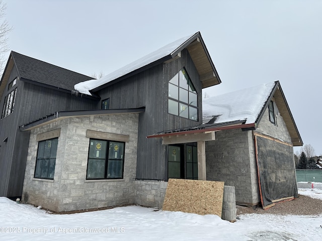 exterior space featuring stone siding