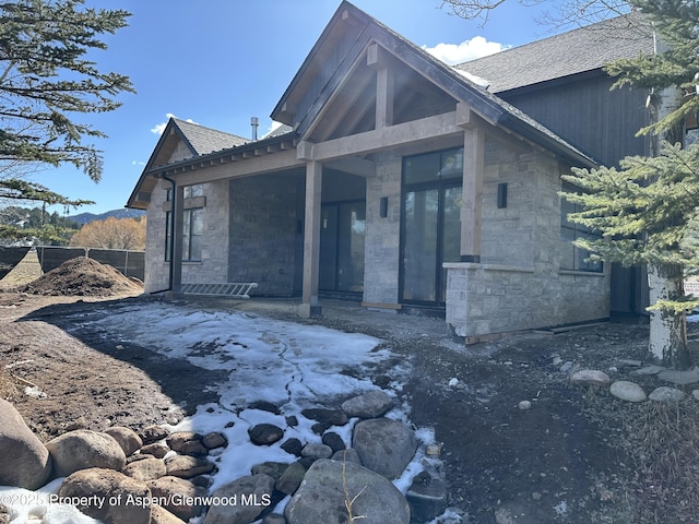 exterior space featuring stone siding