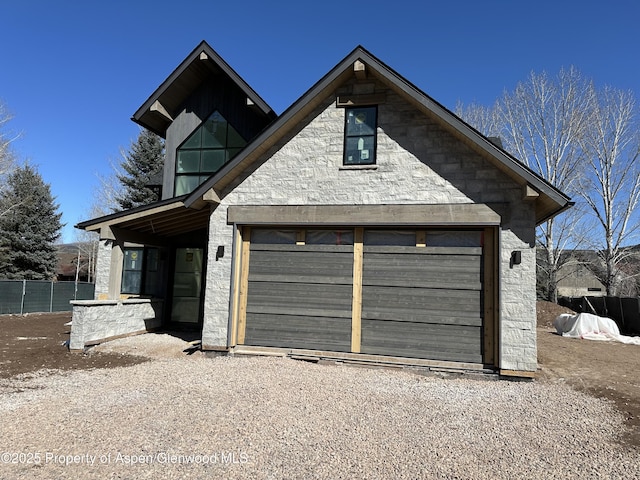 view of front of property with a garage and fence