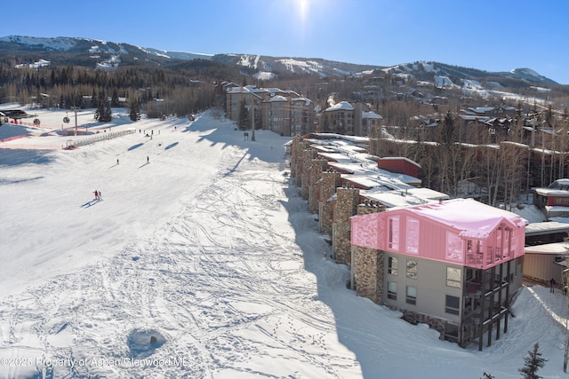 snowy aerial view with a mountain view