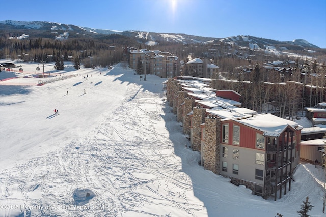 snowy aerial view with a mountain view