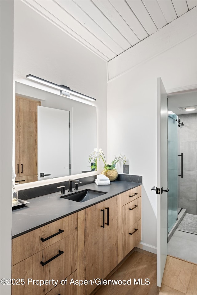 bathroom with vanity, an enclosed shower, and wood ceiling