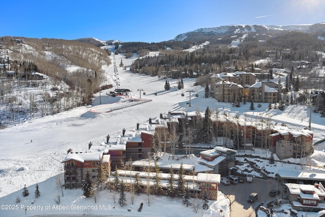 snowy aerial view featuring a mountain view