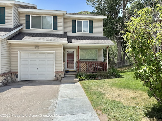 289 Mikala Ln, New Castle, CO 81647 - townhome / multi-family property featuring a shingled roof, covered porch, concrete driveway, and a garage