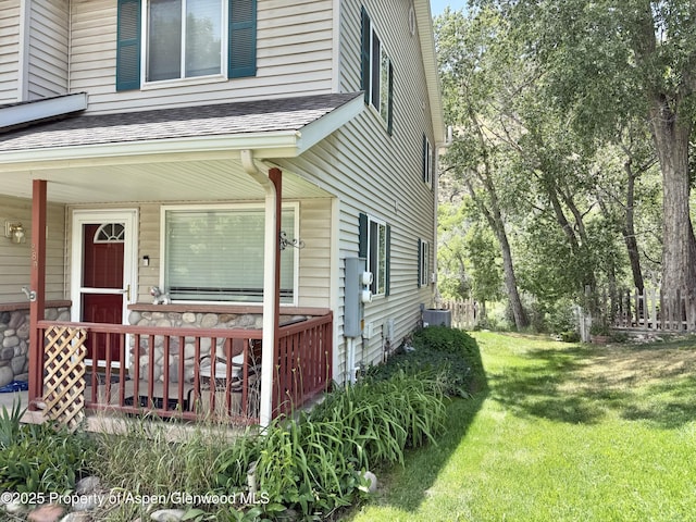 289 Mikala Ln, New Castle, CO 81647 - view of home's exterior featuring covered porch, a shingled roof, and a lawn