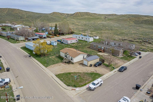 birds eye view of property featuring a mountain view