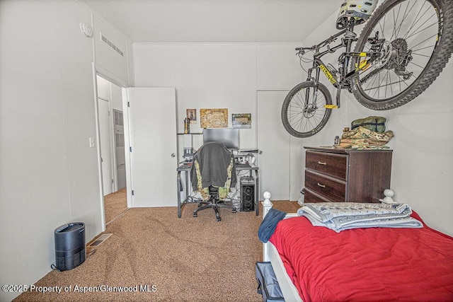 carpeted bedroom with visible vents and ornamental molding