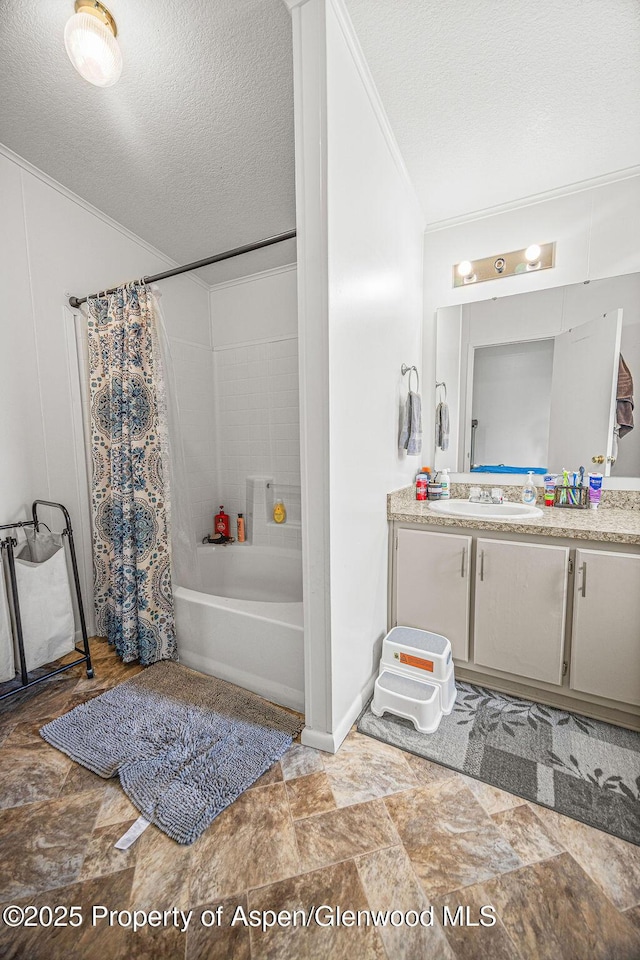 full bath with shower / bathtub combination with curtain, ornamental molding, stone finish flooring, vanity, and a textured ceiling