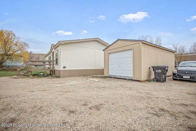 detached garage featuring driveway