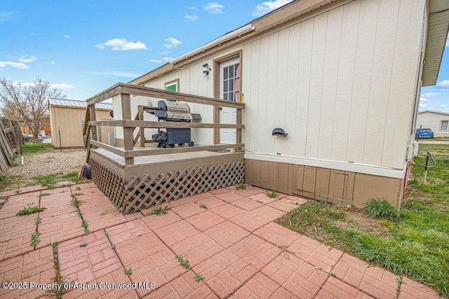 view of patio / terrace with a deck and a grill