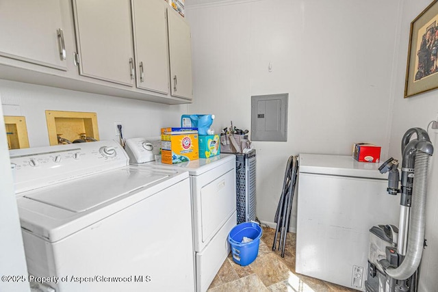 laundry room featuring baseboards, cabinet space, separate washer and dryer, and electric panel