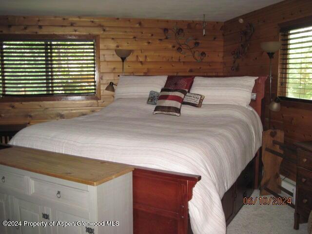 bedroom with wood walls