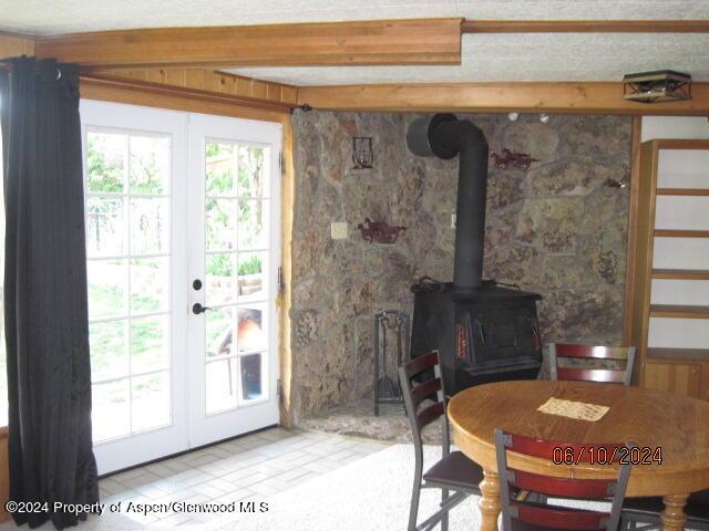 interior space featuring french doors and a wood stove