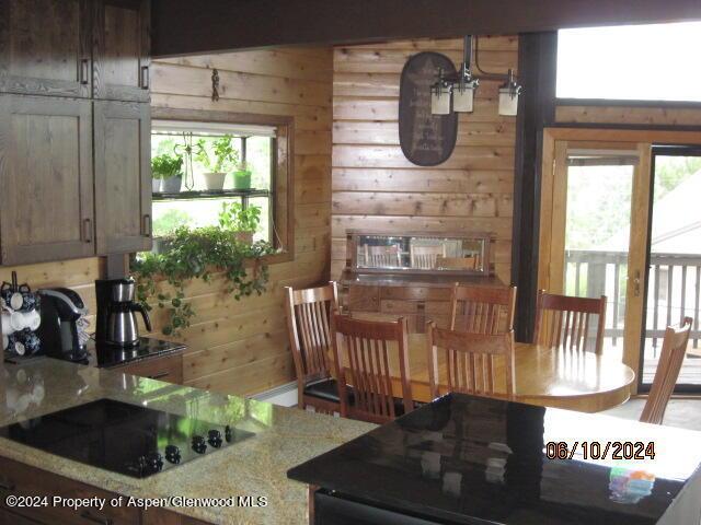 dining room featuring wooden walls