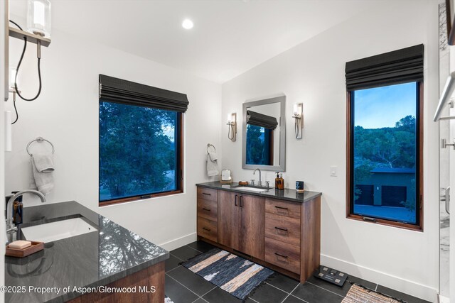 1108 County Road 110, Glenwood Springs, CO 81601 - full bath with two vanities, tile patterned flooring, and baseboards