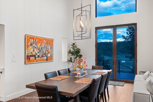 1108 County Road 110, Glenwood Springs, CO 81601 - dining room featuring a high ceiling, light wood-style flooring, and baseboards