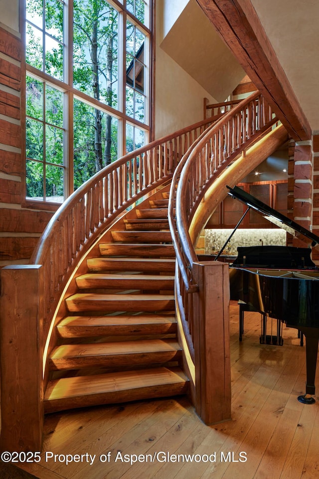 143 N Conundrum Creek Rd, Aspen, CO 81611 - stairway with hardwood / wood-style floors and a high ceiling