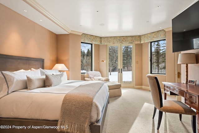 bedroom with access to exterior, multiple windows, french doors, and light colored carpet