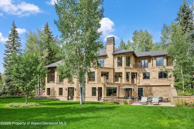 64 Pitkin Way, Aspen, CO 81611 - rear view of house with a balcony, a yard, and a patio