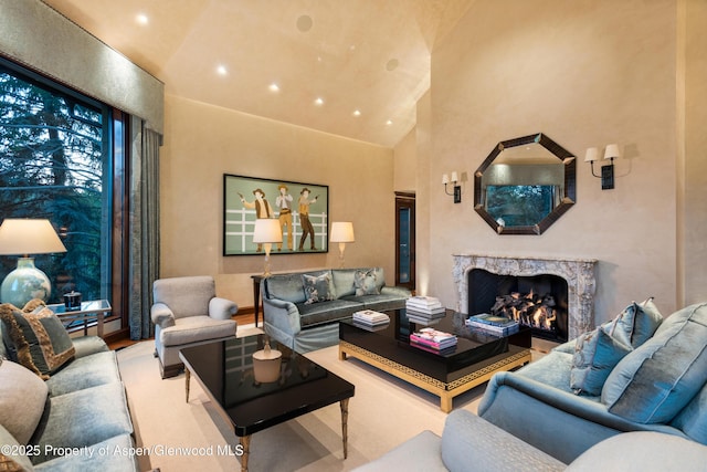 64 Pitkin Way, Aspen, CO 81611 - living area with high vaulted ceiling, a high end fireplace, wood finished floors, and recessed lighting