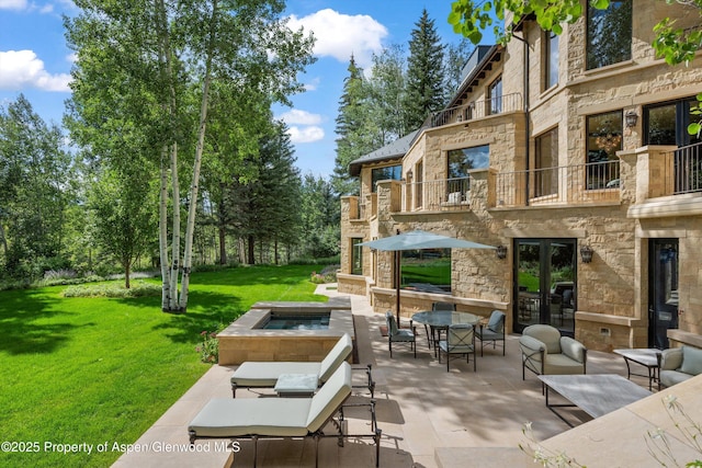 64 Pitkin Way, Aspen, CO 81611 - view of patio with french doors, a balcony, and an outdoor living space