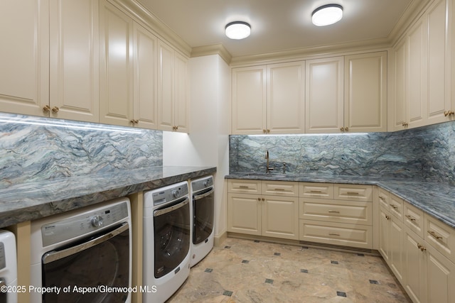 64 Pitkin Way, Aspen, CO 81611 - laundry room featuring washing machine and dryer, indoor wet bar, cabinet space, and a sink