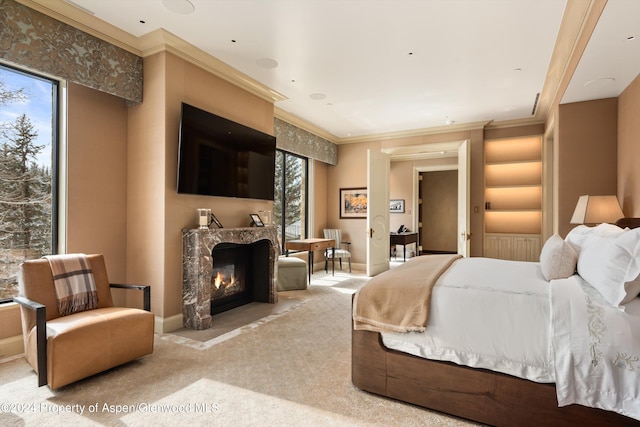 bedroom with baseboards, a high end fireplace, ornamental molding, and light colored carpet