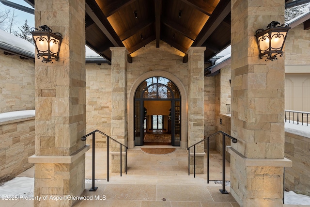 property entrance featuring stone siding