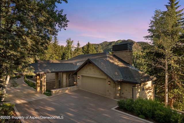 64 Pitkin Way, Aspen, CO 81611 - chalet / cabin featuring a chimney, driveway, stone siding, a mountain view, and a garage