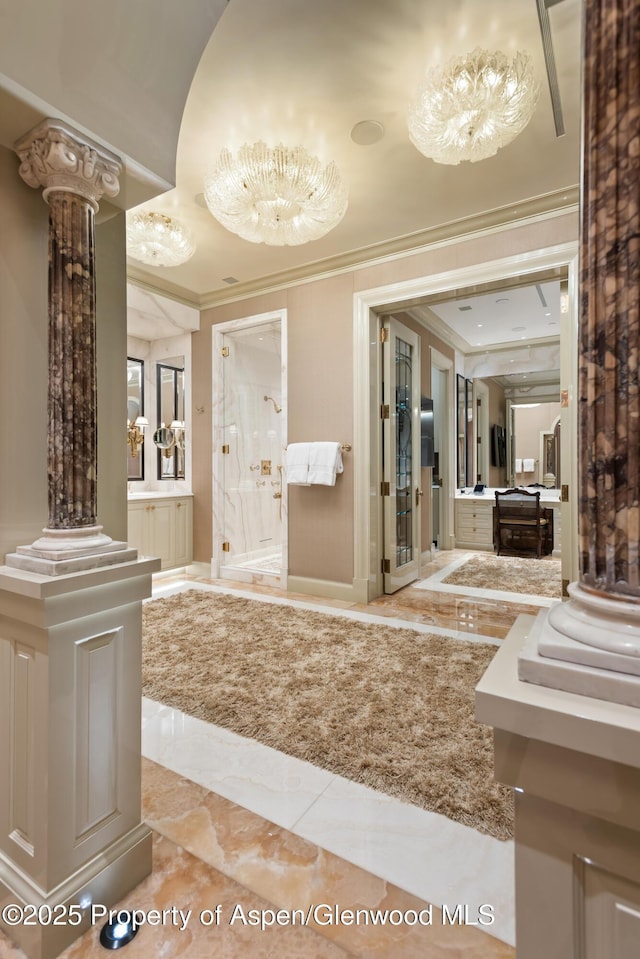 64 Pitkin Way, Aspen, CO 81611 - bathroom featuring decorative columns, marble finish floor, a shower stall, and ornamental molding
