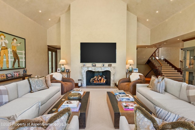 64 Pitkin Way, Aspen, CO 81611 - living room featuring high vaulted ceiling, a high end fireplace, recessed lighting, and stairway