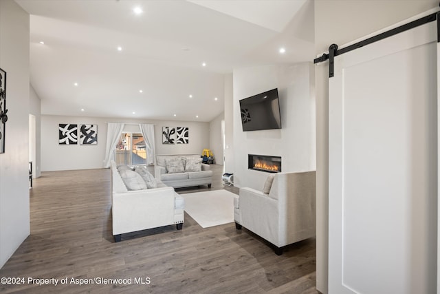 living room with hardwood / wood-style floors and a barn door