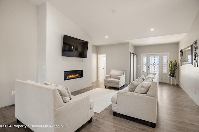 living room with hardwood / wood-style floors and lofted ceiling