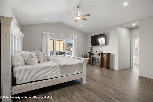 bedroom featuring dark hardwood / wood-style floors, ceiling fan, lofted ceiling, and ensuite bathroom