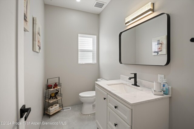 bathroom with vanity and toilet