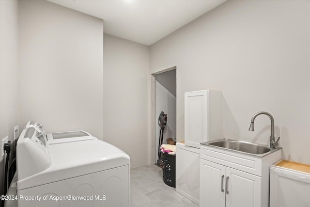 laundry room with washer and dryer and sink